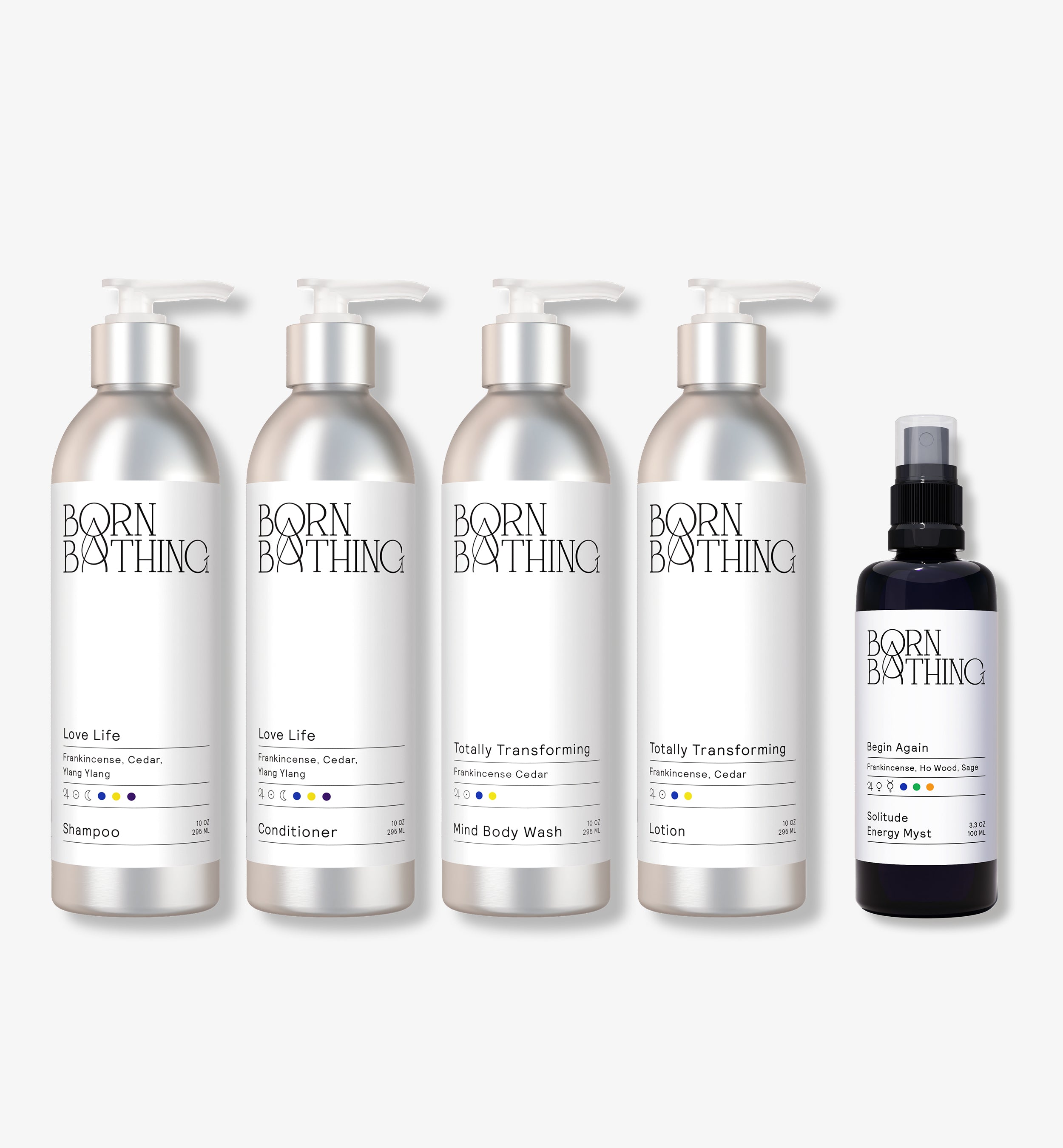 A set of five Born Bathing body care products, including various body washes and a room spray, with labels featuring essential oil names such as blackberry seed oil, frankincense, and ylang ylang flower.